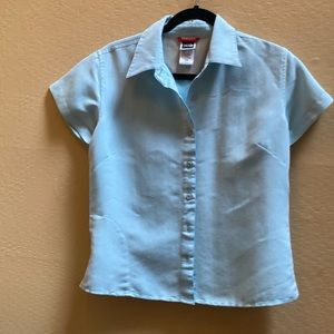 Short sleeved sporty shirt. Light blue with zippered picket on side